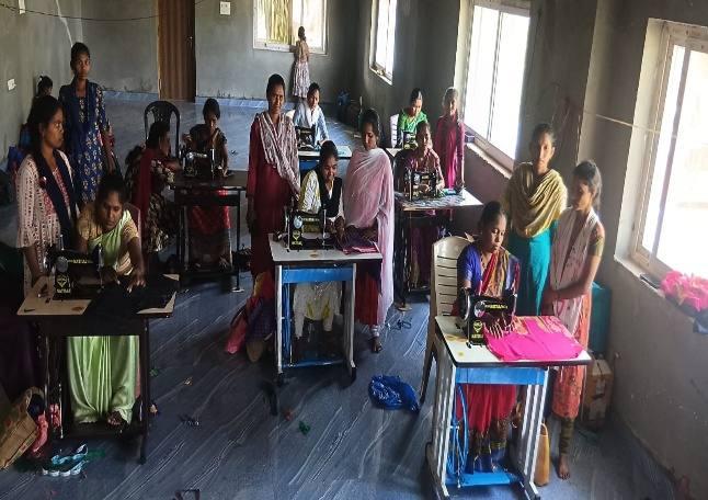 Women practising tailoring in the skill development programme